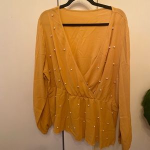 Mustard yellow surplice top with pearl detailing.